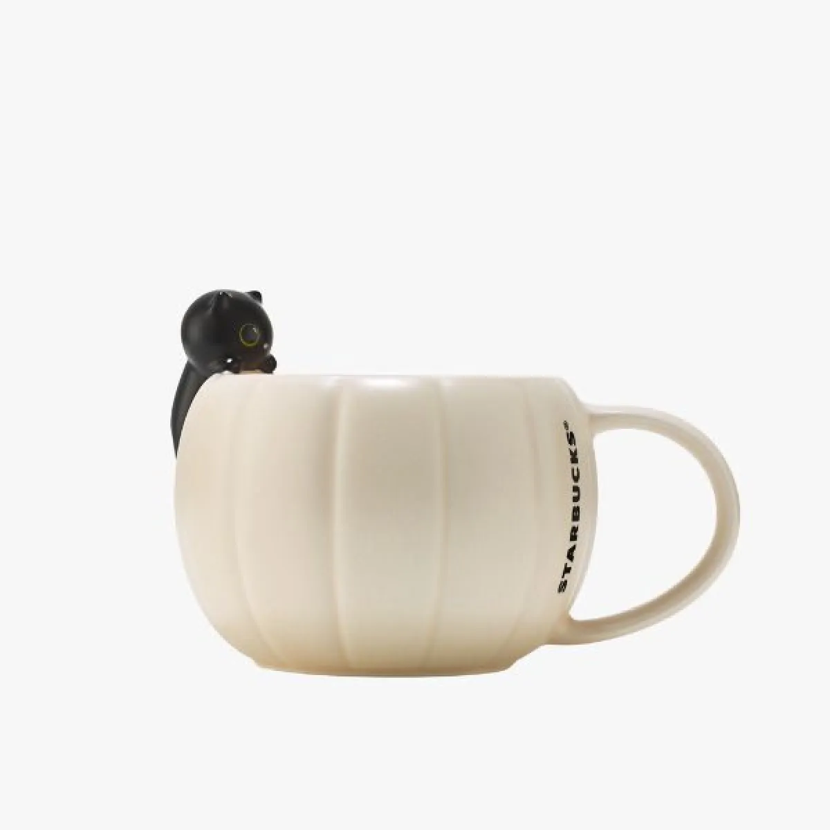 white pumpkin-shaped mug with a black cat on its side