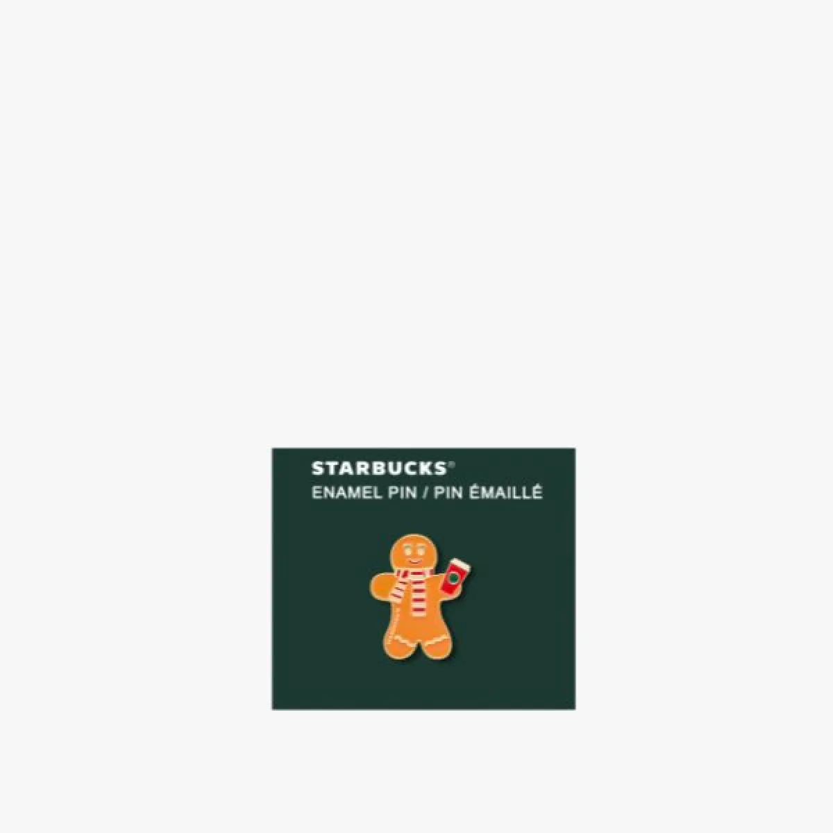 Enamel badge (pin) in the shape of a gingerbread man holding a red cup, on a dark green card