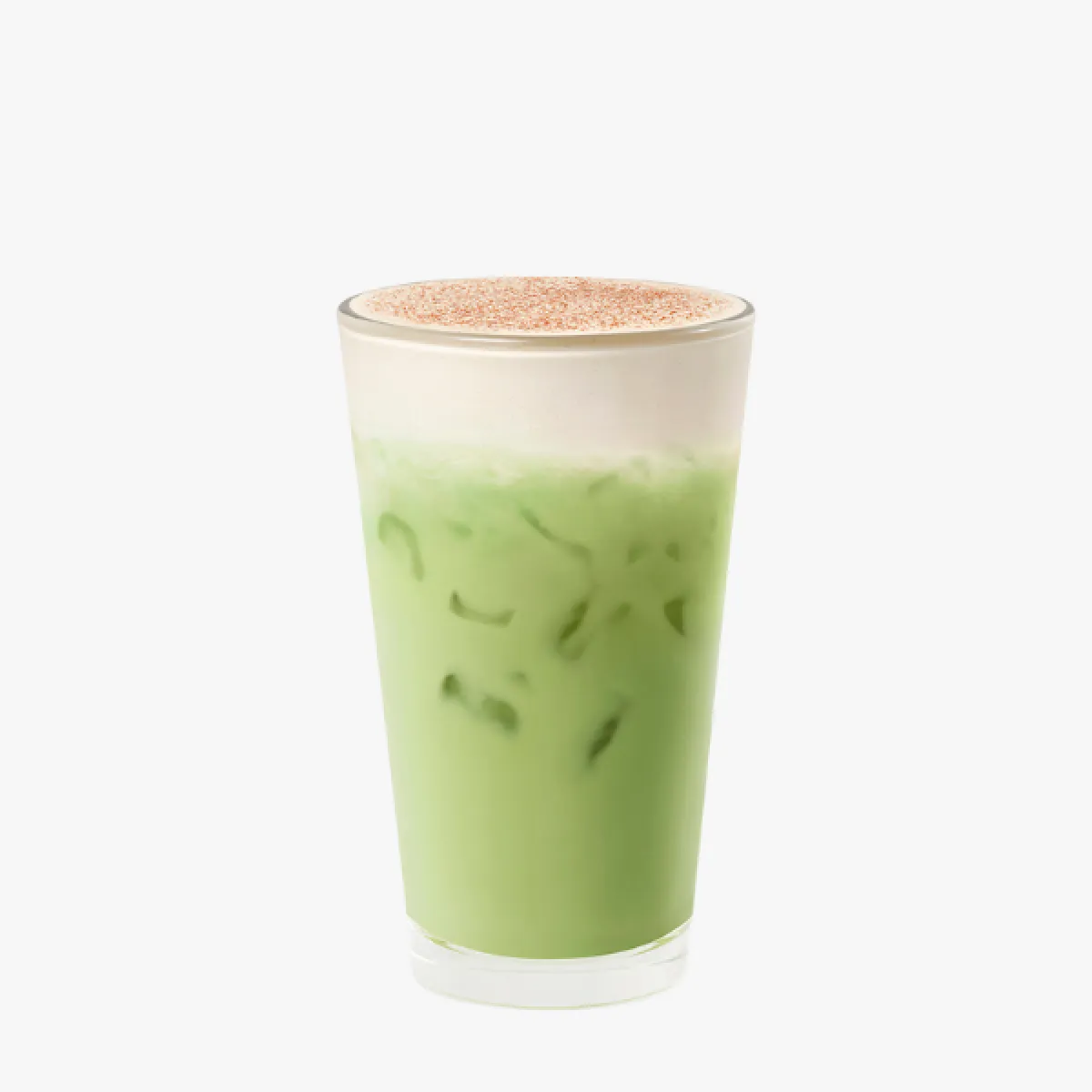 green drink in a glass with cream cold foam and cinnamon sprinkles