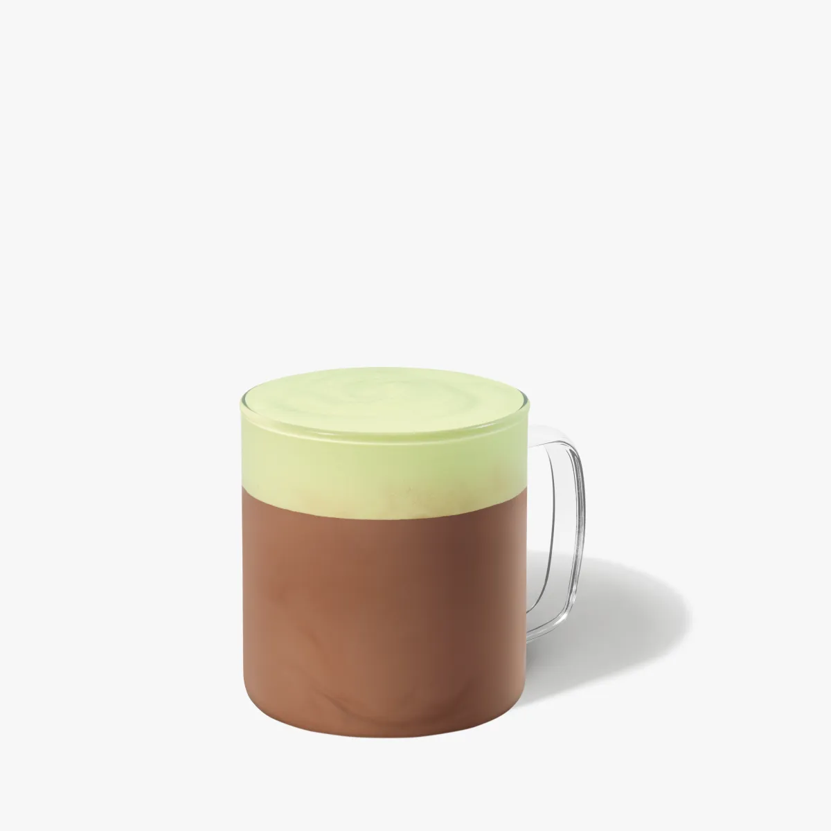 tmavo hnedý nápoj so zelenou penou navrchu