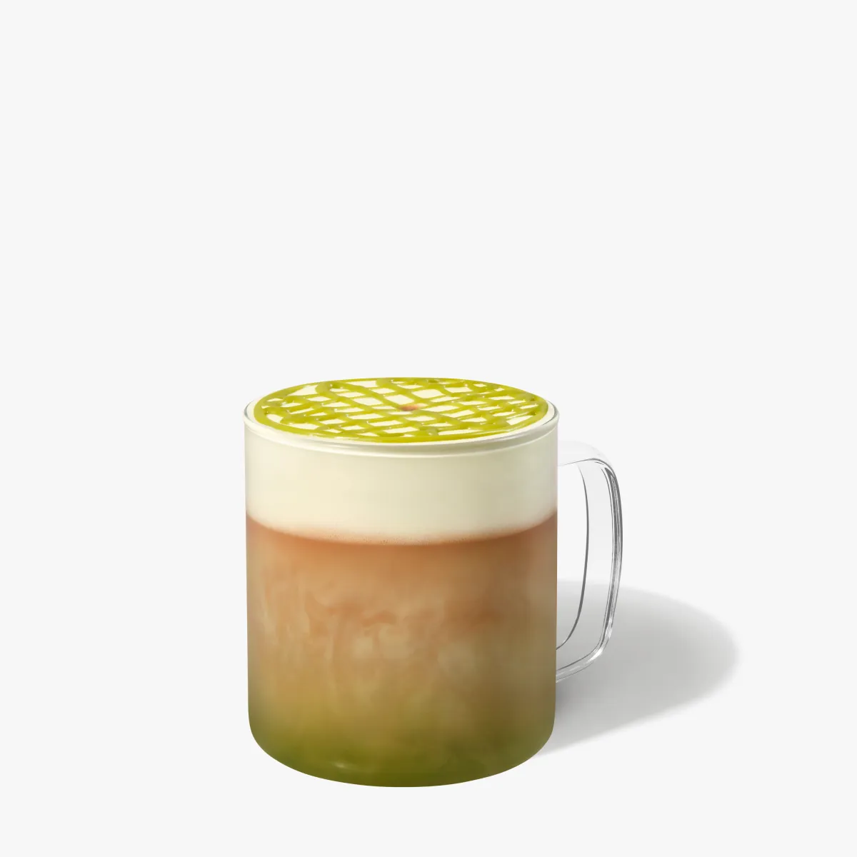 svetlo hnedý nápoj s penou navrchu a so zelenou polavou