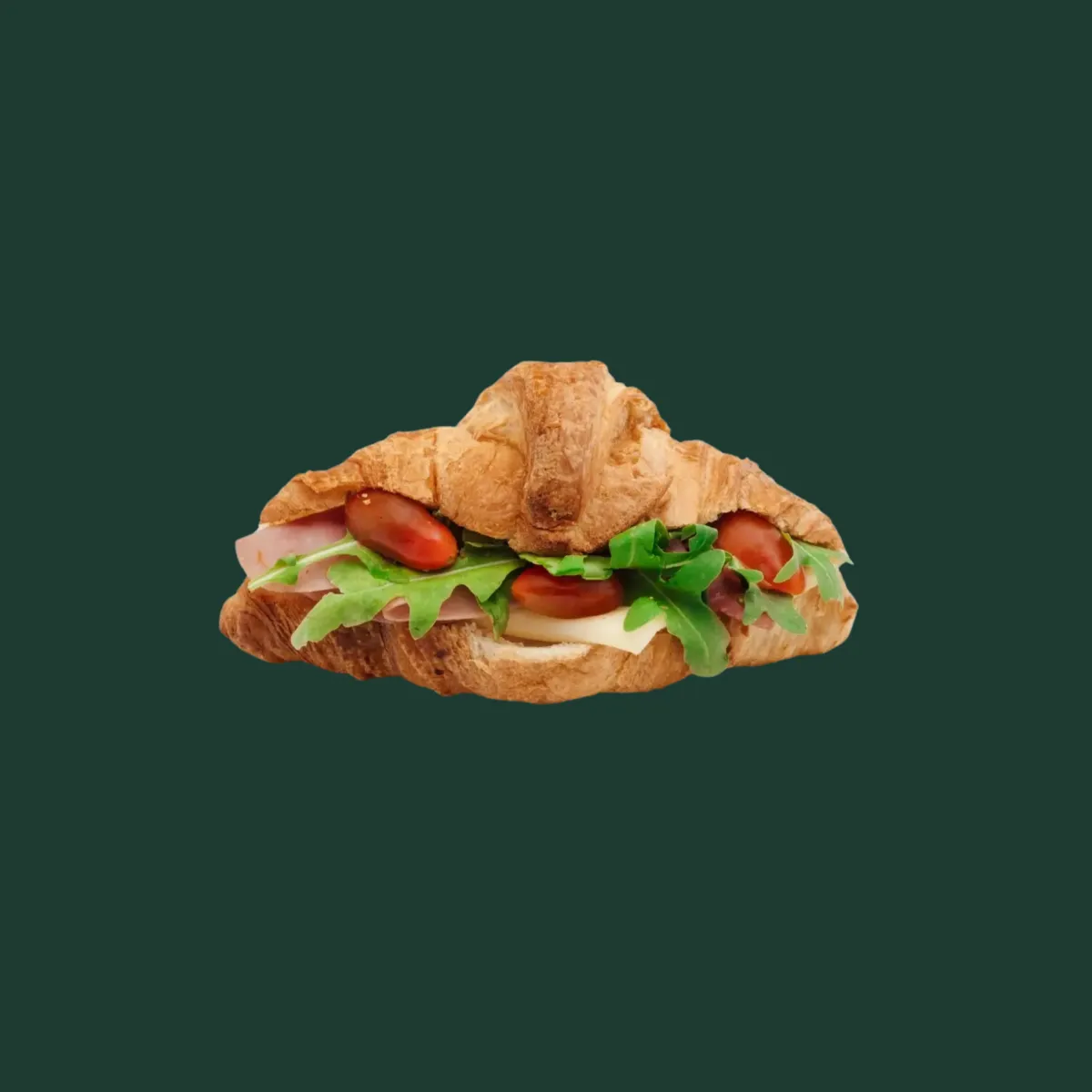 Croissant plnený šunkou, plátkom syra, paradajkami a listami růkoly.