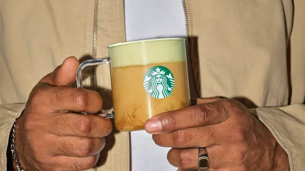 človek držiaci nápoj v šálke